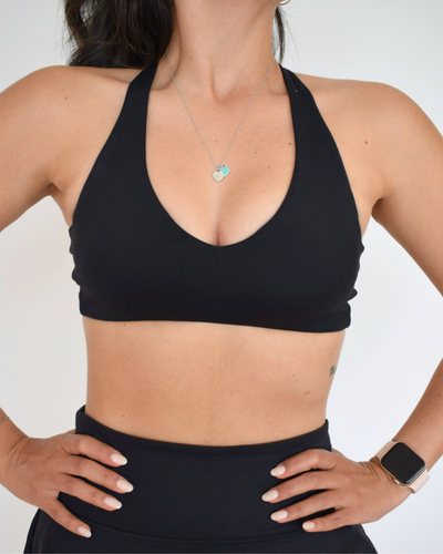 Detalle frontal del Core Loop Bra negro de Muv&Glow, escote en V con costuras suaves y fit cómodo.
