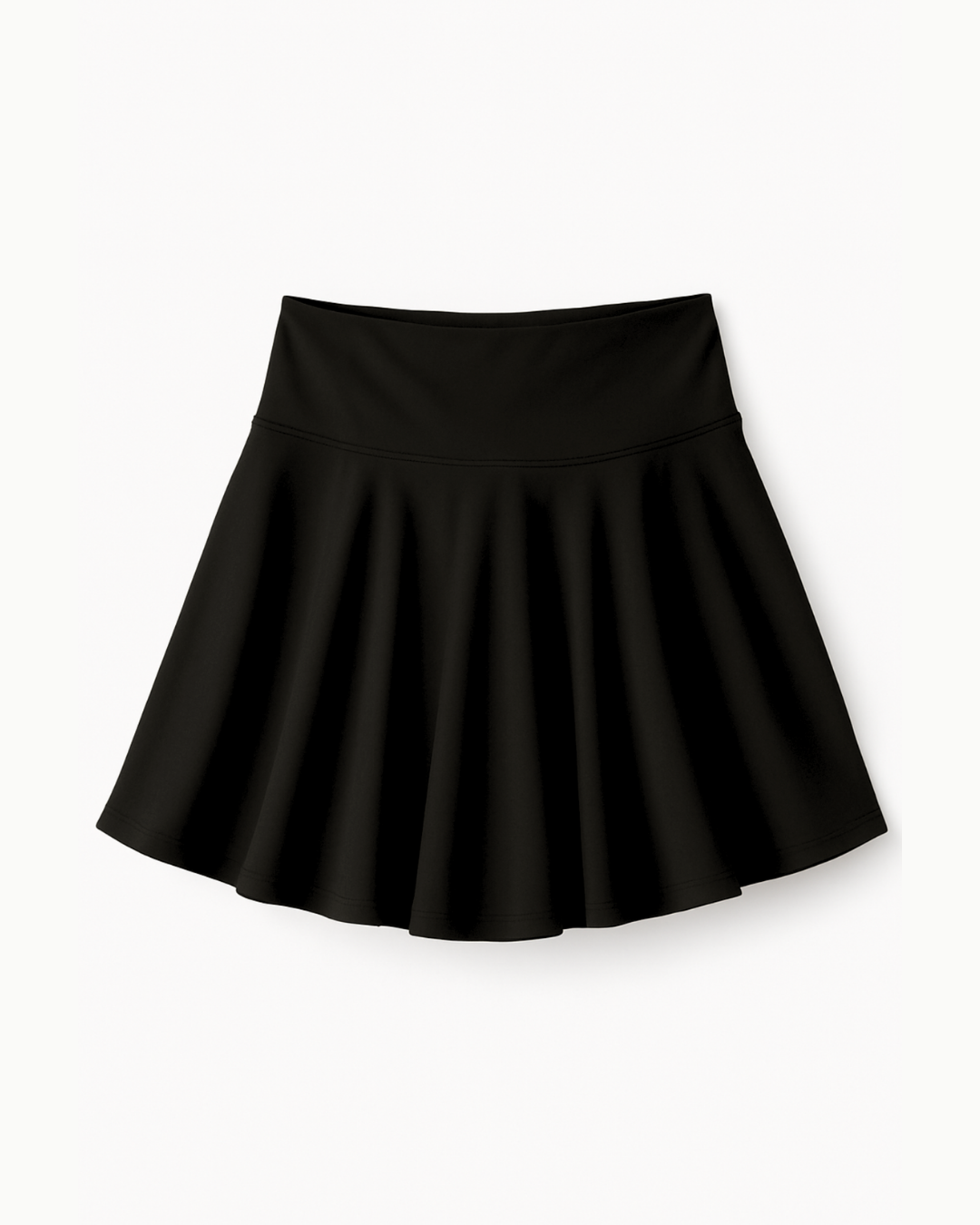 Flat lay de The Core Skirt negro de Muv&Glow sobre fondo blanco, falda deportiva con short interior.

