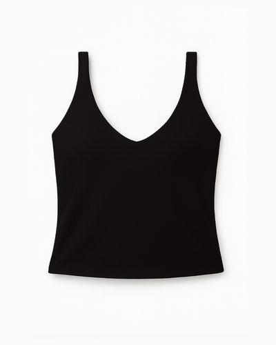 Flat lay del Core Twist Top negro de Muv&Glow sobre fondo blanco, top largo con tirantes cruzados.
