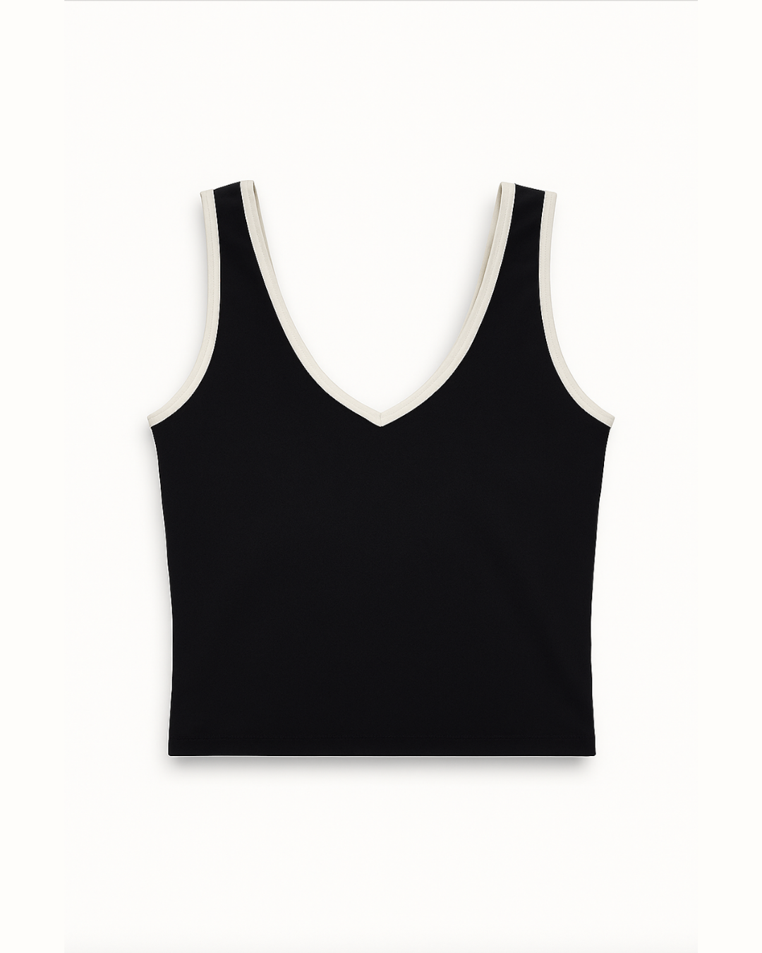 Flat lay del Icon Top negro con ribete blanco de Muv&Glow
